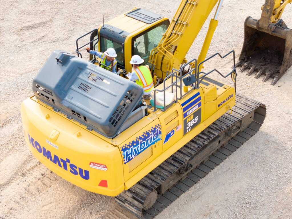 Heavy Equipment Operator and Area ES&H Supervisor atop the Hybrid excavator.